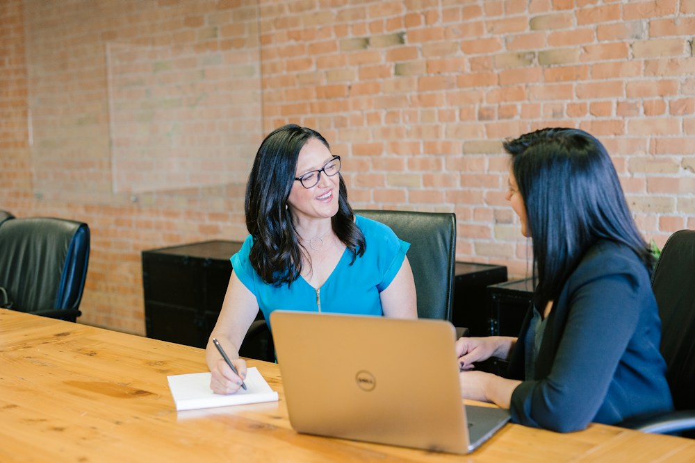 Colleagues discussing work around a table